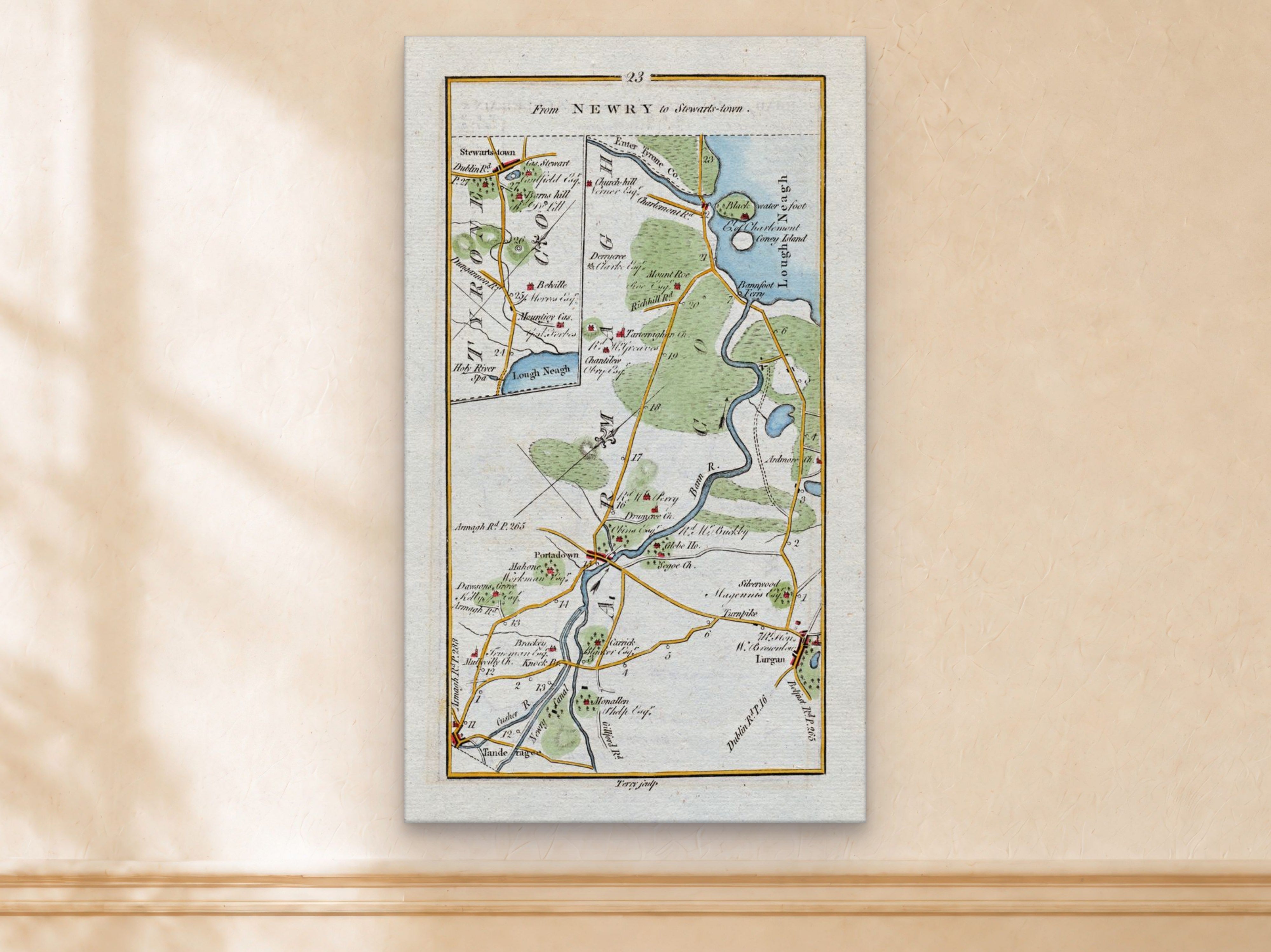1783 Taylor & Skinner Stewartstown, Portadown, Lurgan, Tandragee and Lough Neagh Ireland road map displayed on a light cream wall.