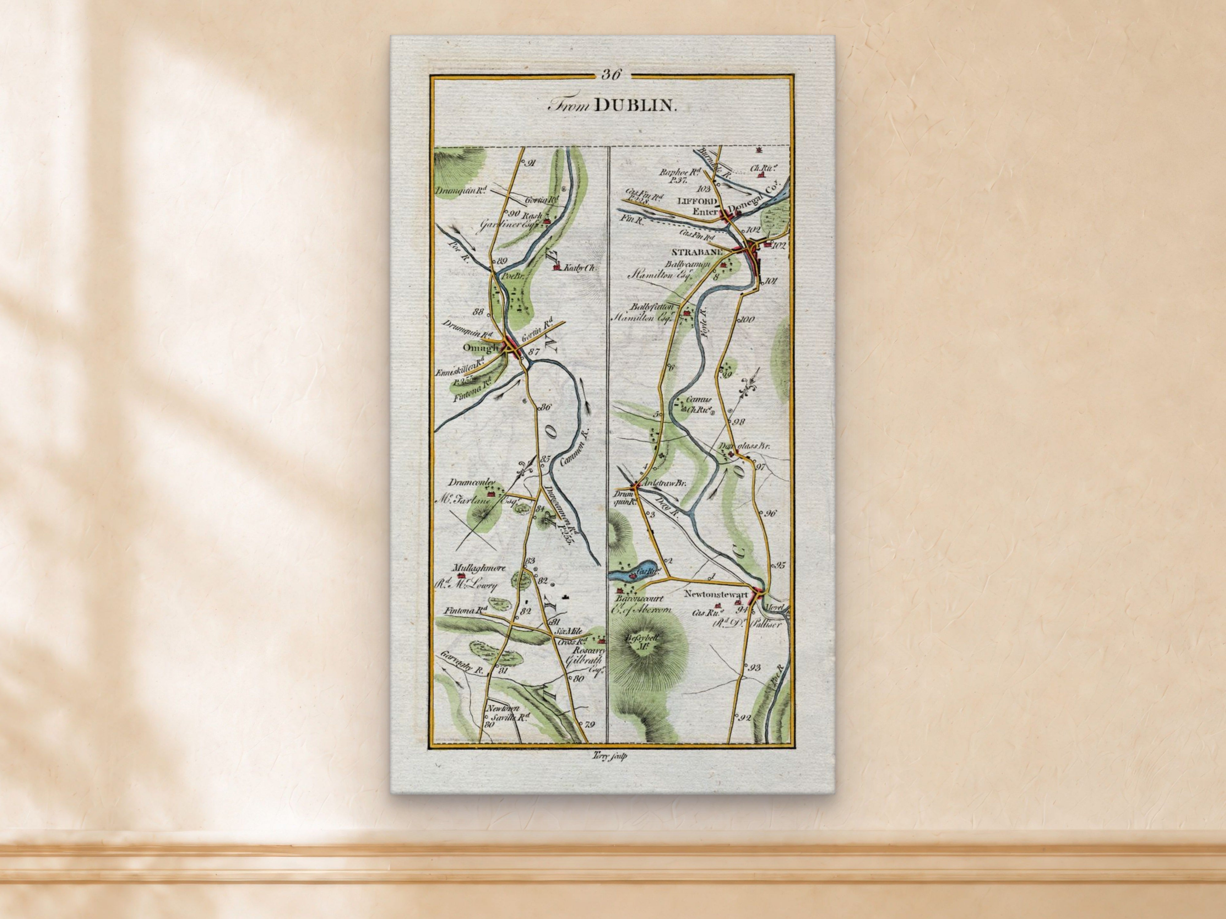 1783 Taylor & Skinner Strabane, Lifford, Omagh and Newtownstewart, Tyrone and Donegal Ireland road map displayed on a light cream wall. The map covers Counties Tyrone and Donegal.