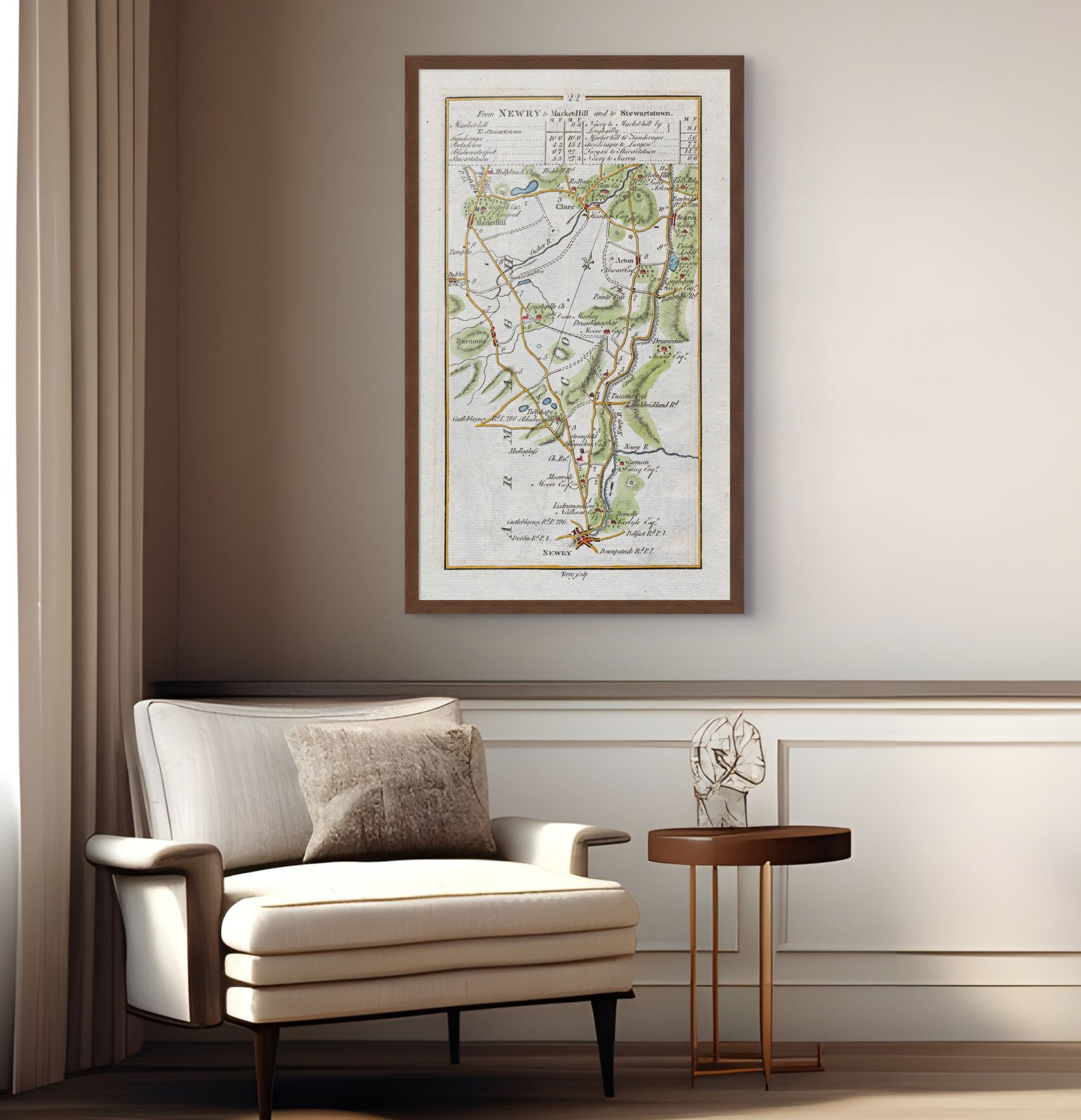 1783 Taylor & Skinner Newry, Markethill, Scarva, Poyntzpass and Loughgilly Ireland road map displayed above an armchair in a neutral interior.