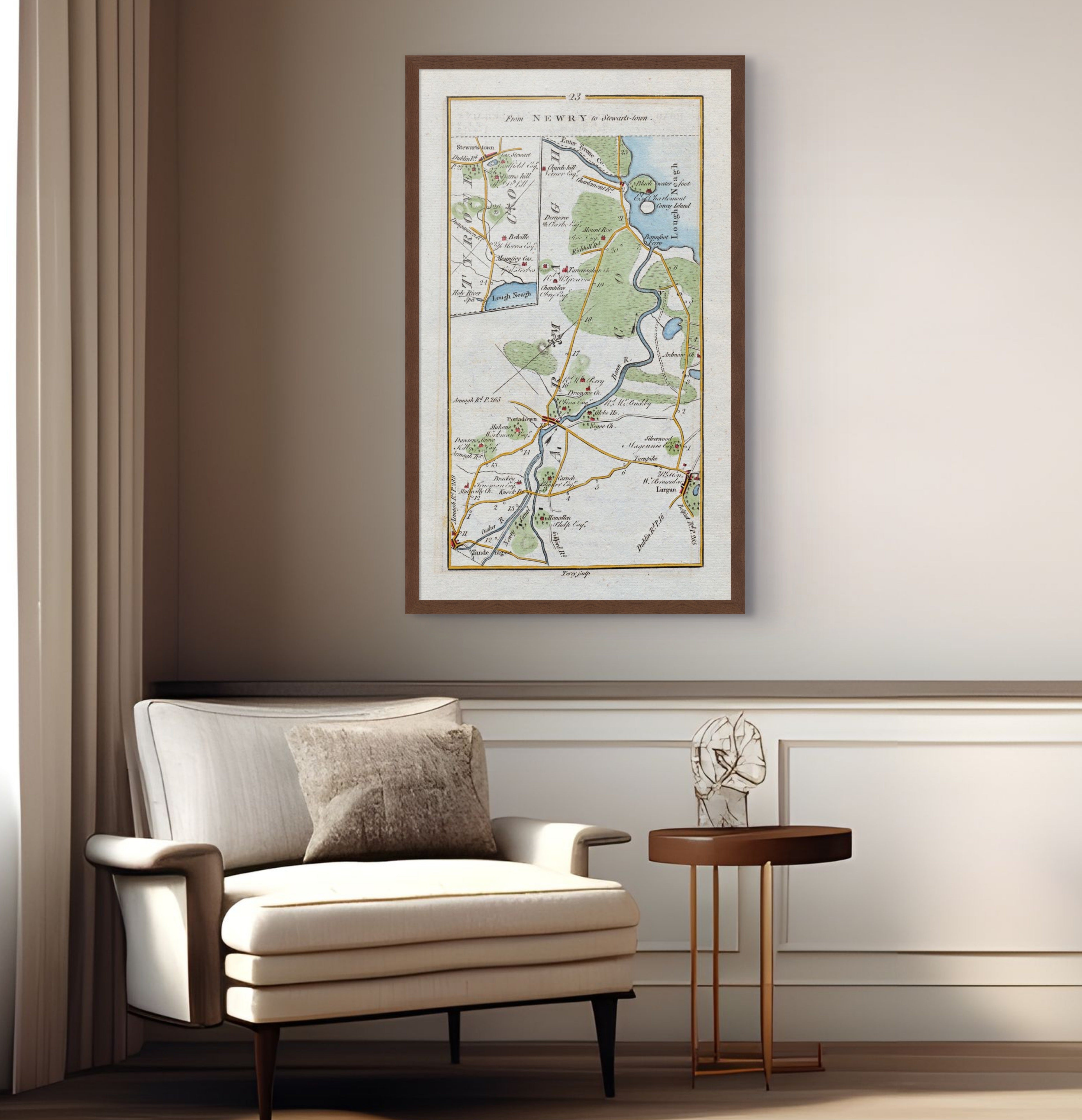 1783 Taylor & Skinner Stewartstown, Portadown, Lurgan, Tandragee and Lough Neagh Ireland road map displayed above an armchair in a neutral interior.
