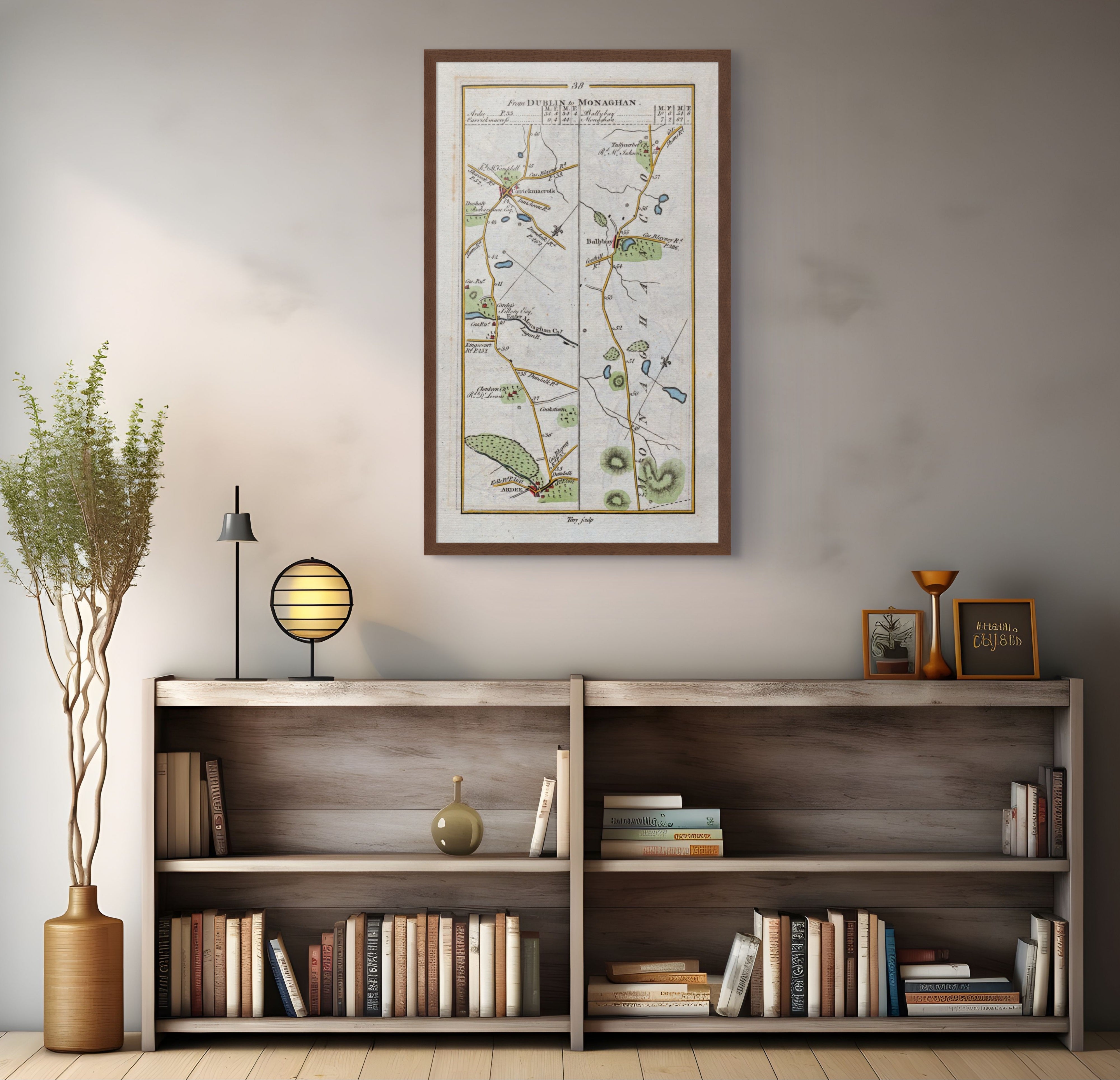 1783 Taylor & Skinner Ardee, Carrickmacross, Ballybay and Monaghan Ireland road map displayed above a bookshelf. The map covers Counties Monaghan and Louth.