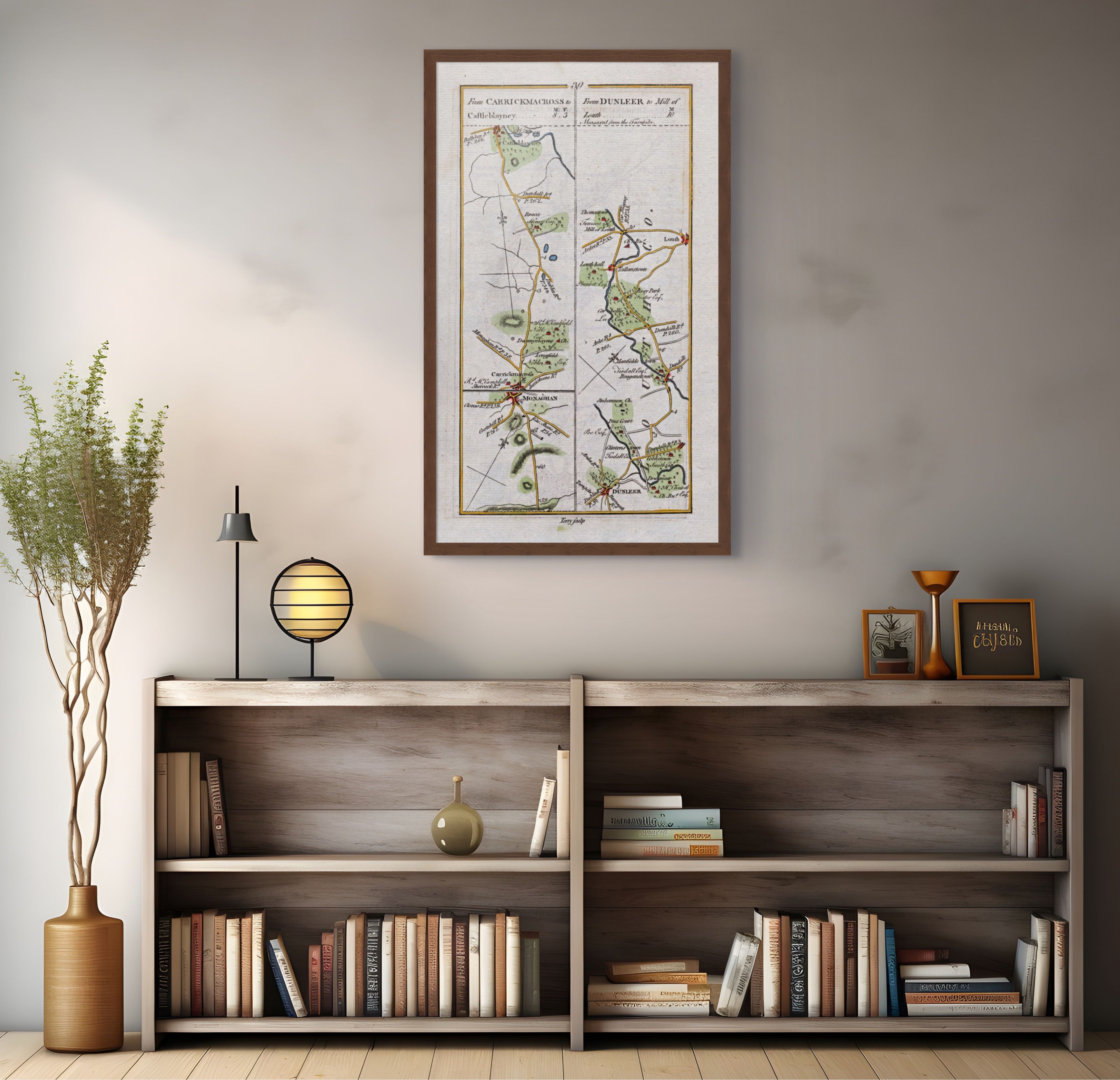 1783 Taylor & Skinner Carrickmacross, Castleblayney, Dunleer, Louth and Monaghan Ireland road map displayed above a bookshelf. The map covers Counties Louth and Monaghan.
