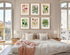 Six framed antique botanical prints from Heinrich Wilhelm Schott's 1879 Aroideae Maximilianae collection arranged in a two-row gallery wall above a white bed with soft blush pink bedding in an elegant, sunlit bedroom.