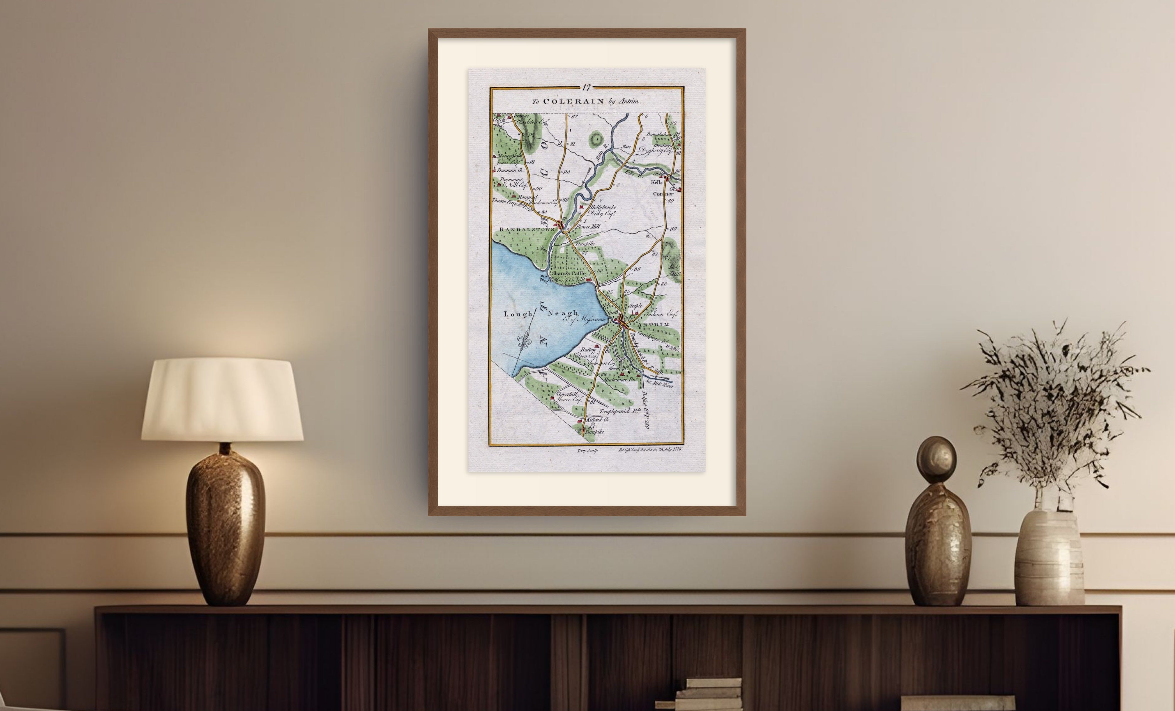 Framed antique Ireland road map of Antrim, Randalstown, Kells, Connor and Grange displayed in a styled room interior.
