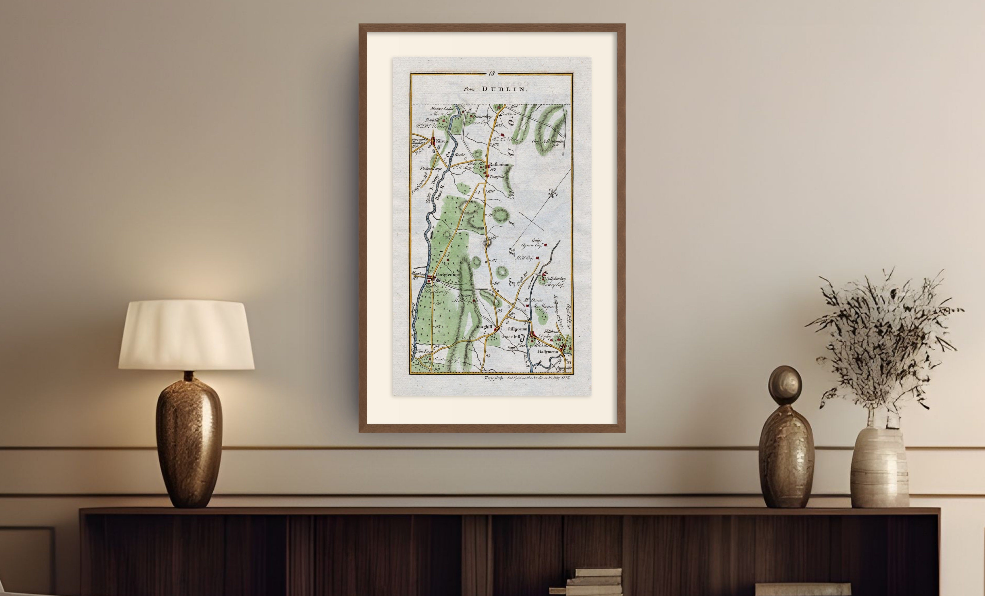 Framed antique Ireland road map of Ballymena, Portglenone, Kilrea and Cullybackey displayed in a styled room interior.