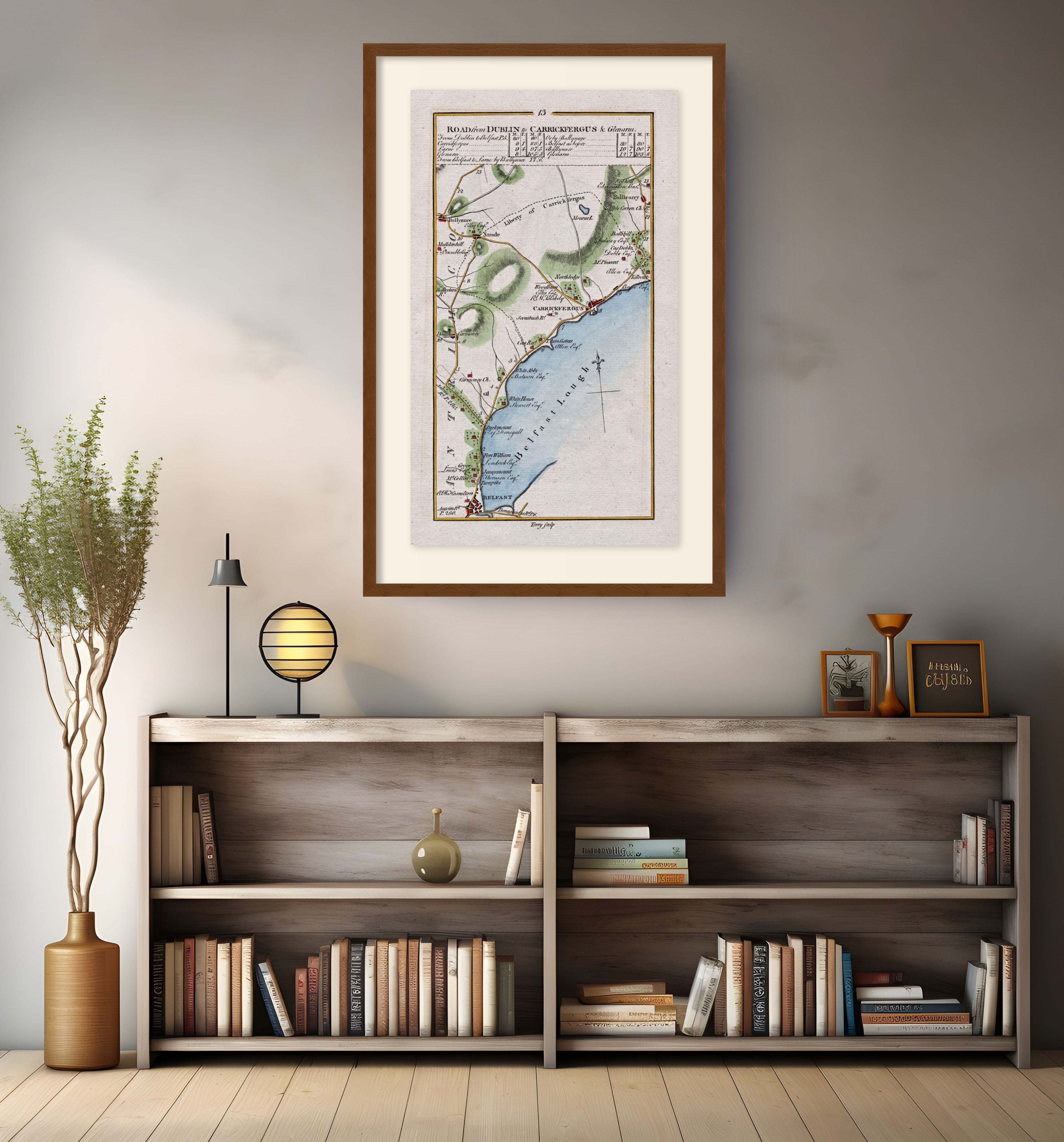 Framed antique Ireland road map of Belfast, Carrickfergus, Ballynure, Whiteabbey and Ballycarry displayed in a modern interior.