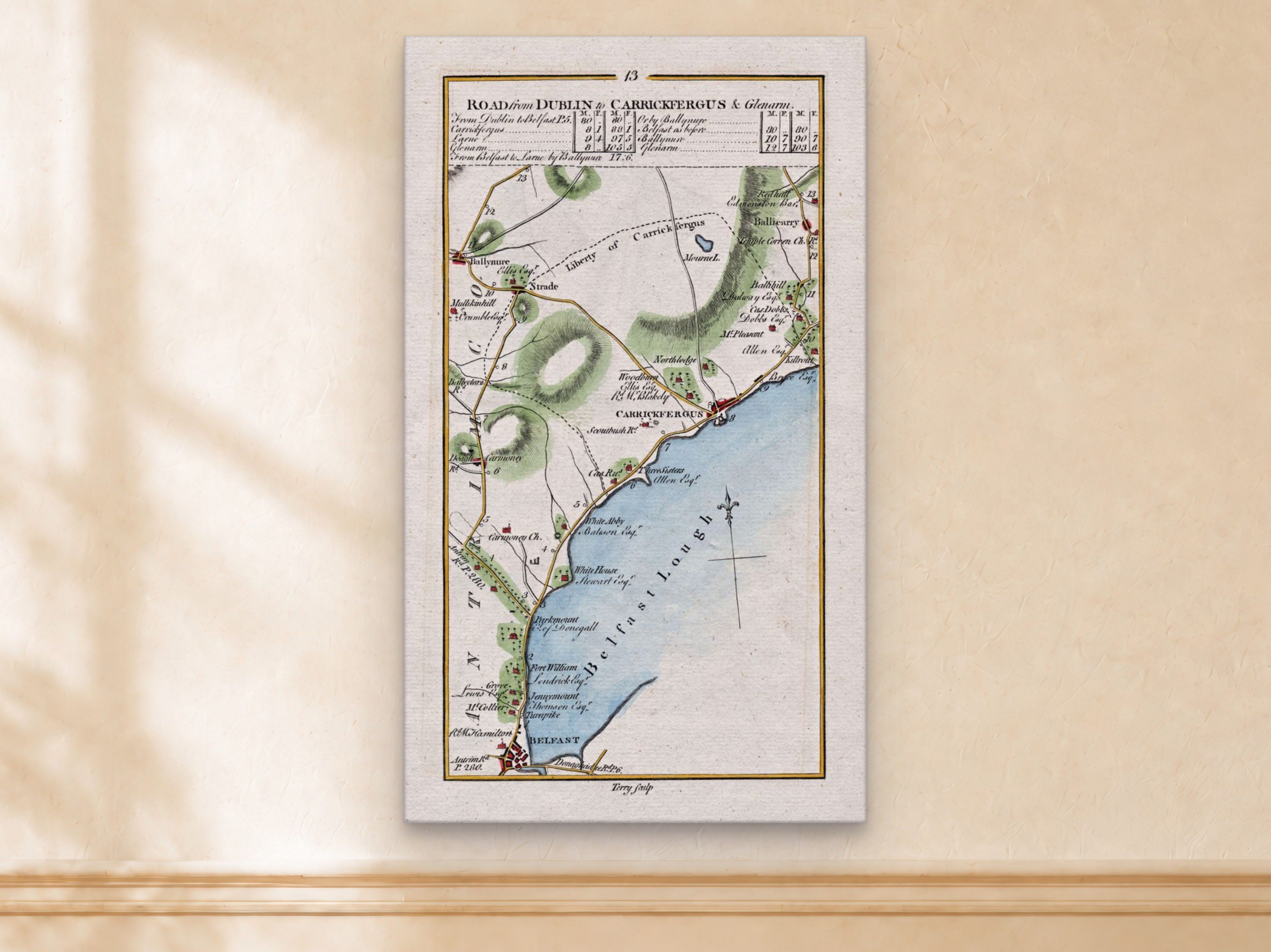 1783 Taylor & Skinner Belfast, Carrickfergus, Ballynure, Whiteabbey and Ballycarry Ireland road map displayed on a light cream wall.