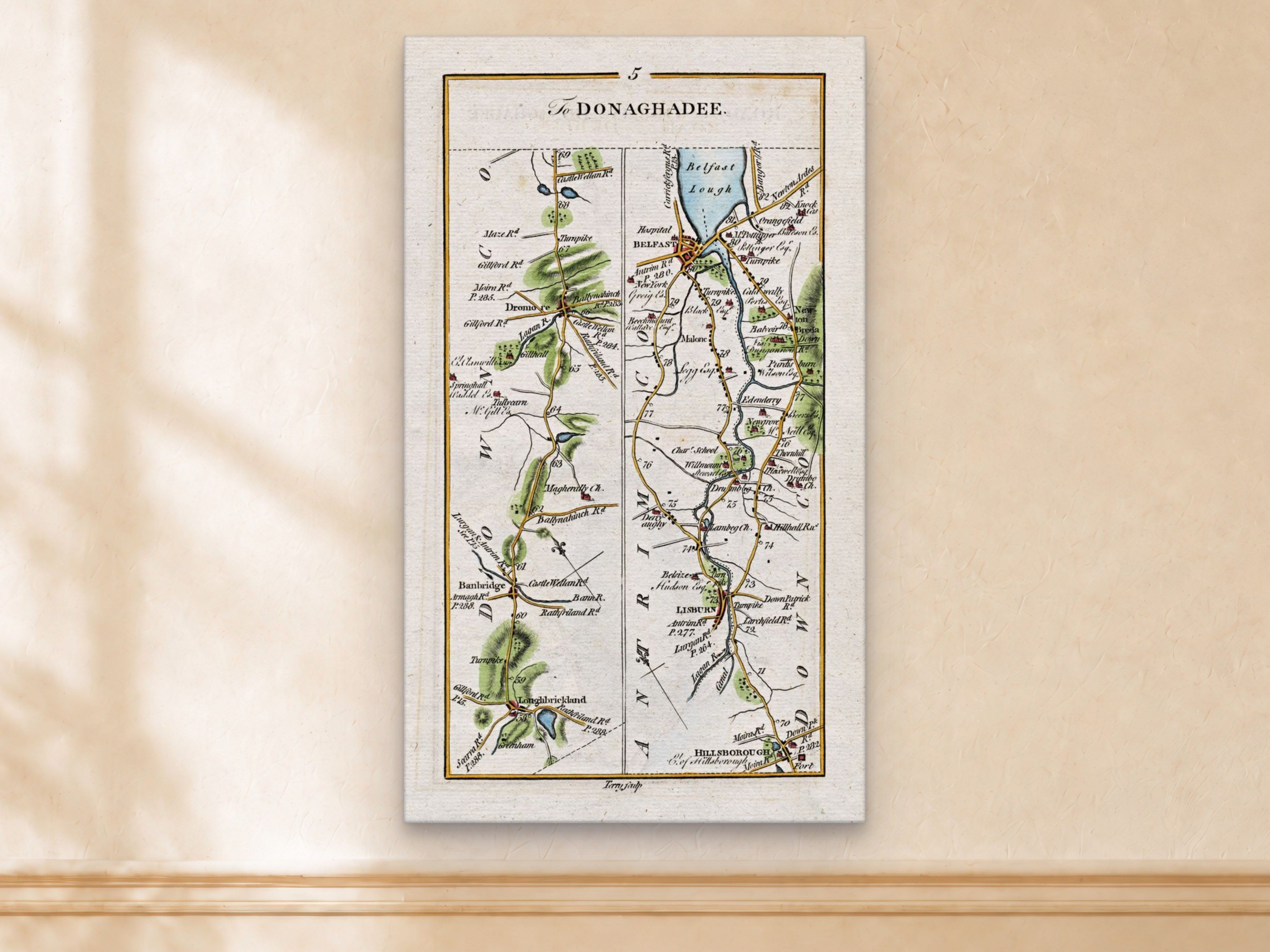 1783 Taylor & Skinner Belfast, Lisburn, Banbridge and Hillsborough Ireland road map displayed on a light cream wall.