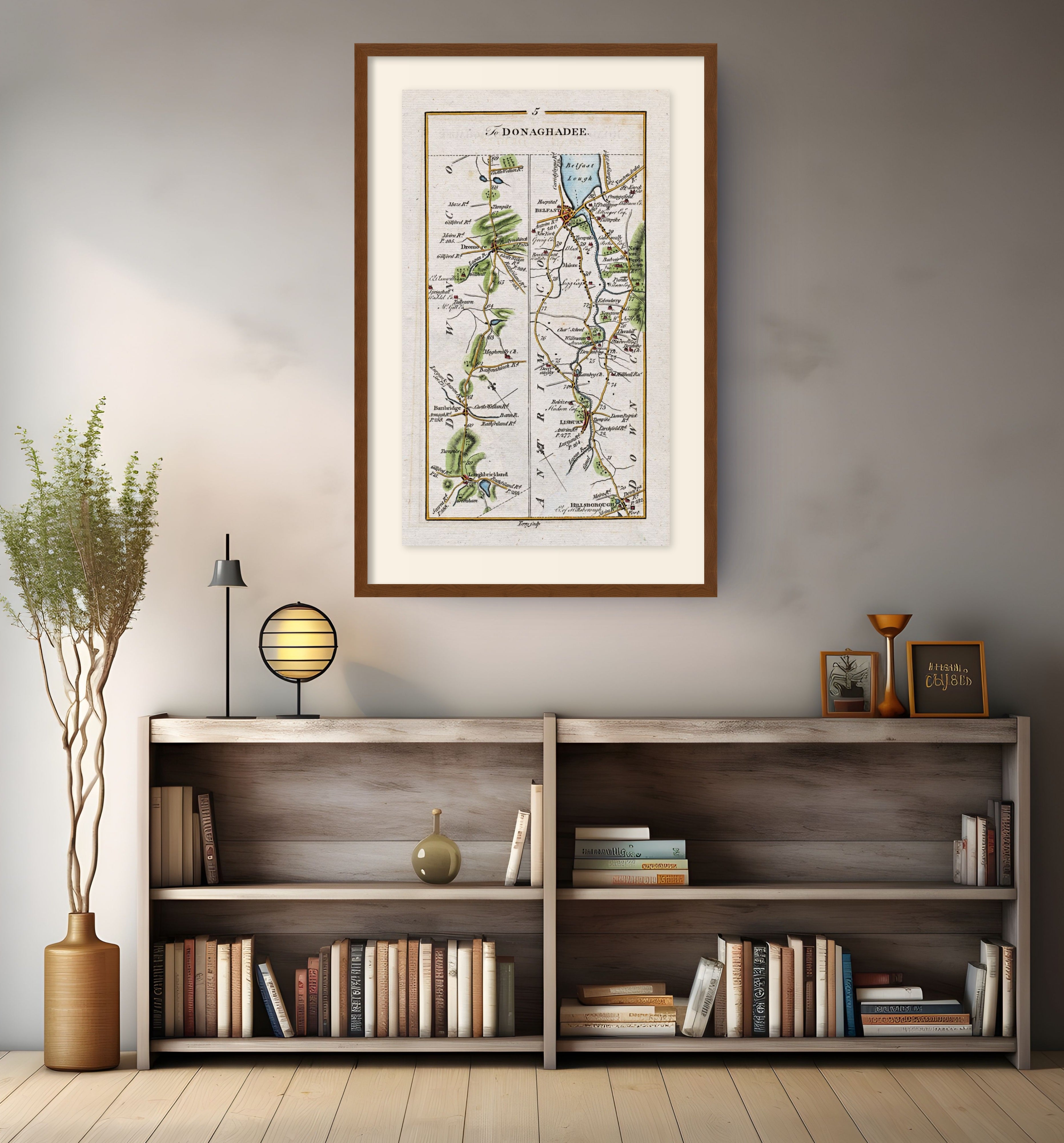 Framed antique Ireland road map of Belfast, Lisburn, Banbridge and Hillsborough displayed in a modern interior.