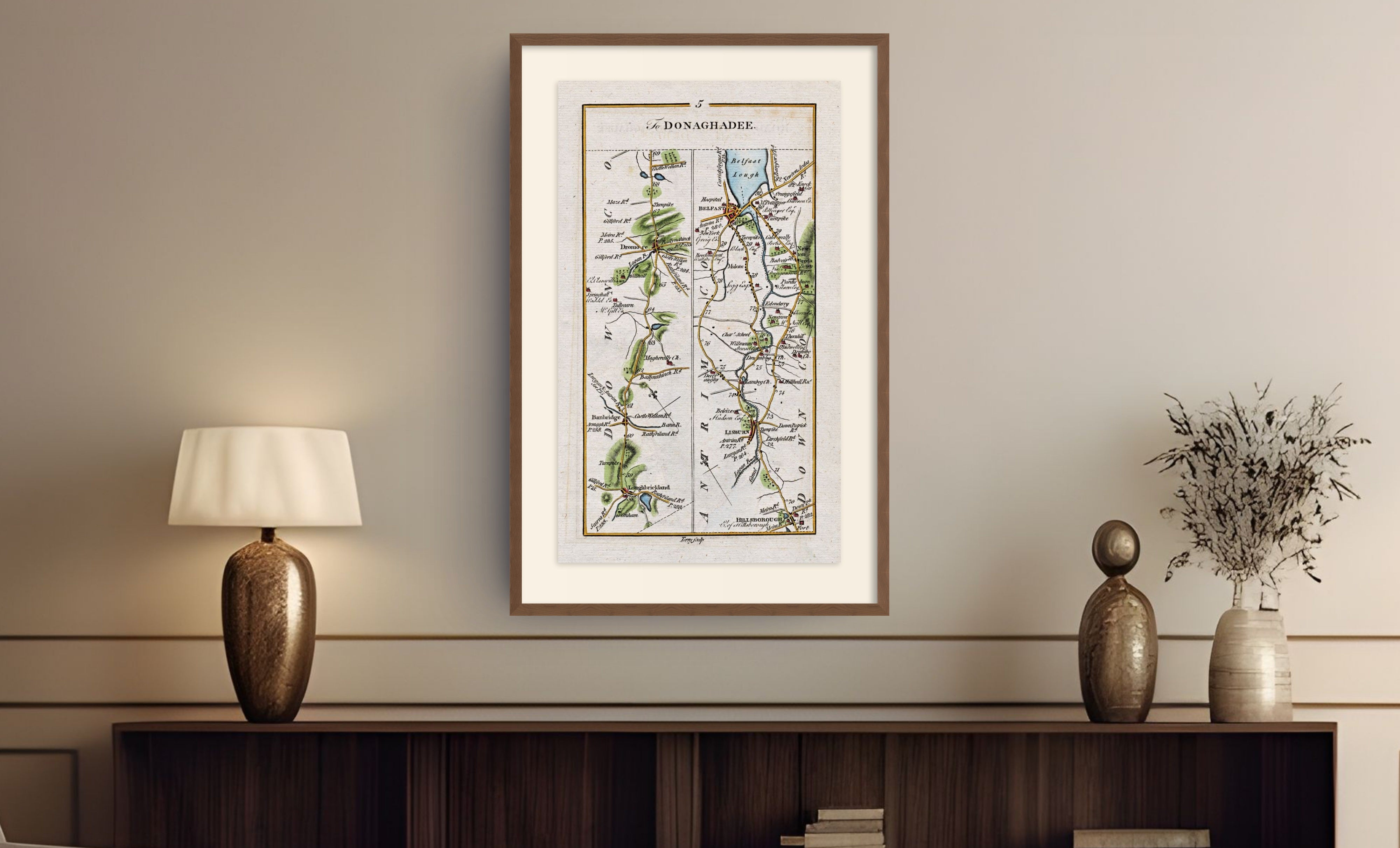Framed antique Ireland road map of Belfast, Lisburn, Banbridge and Hillsborough displayed in a styled room interior.