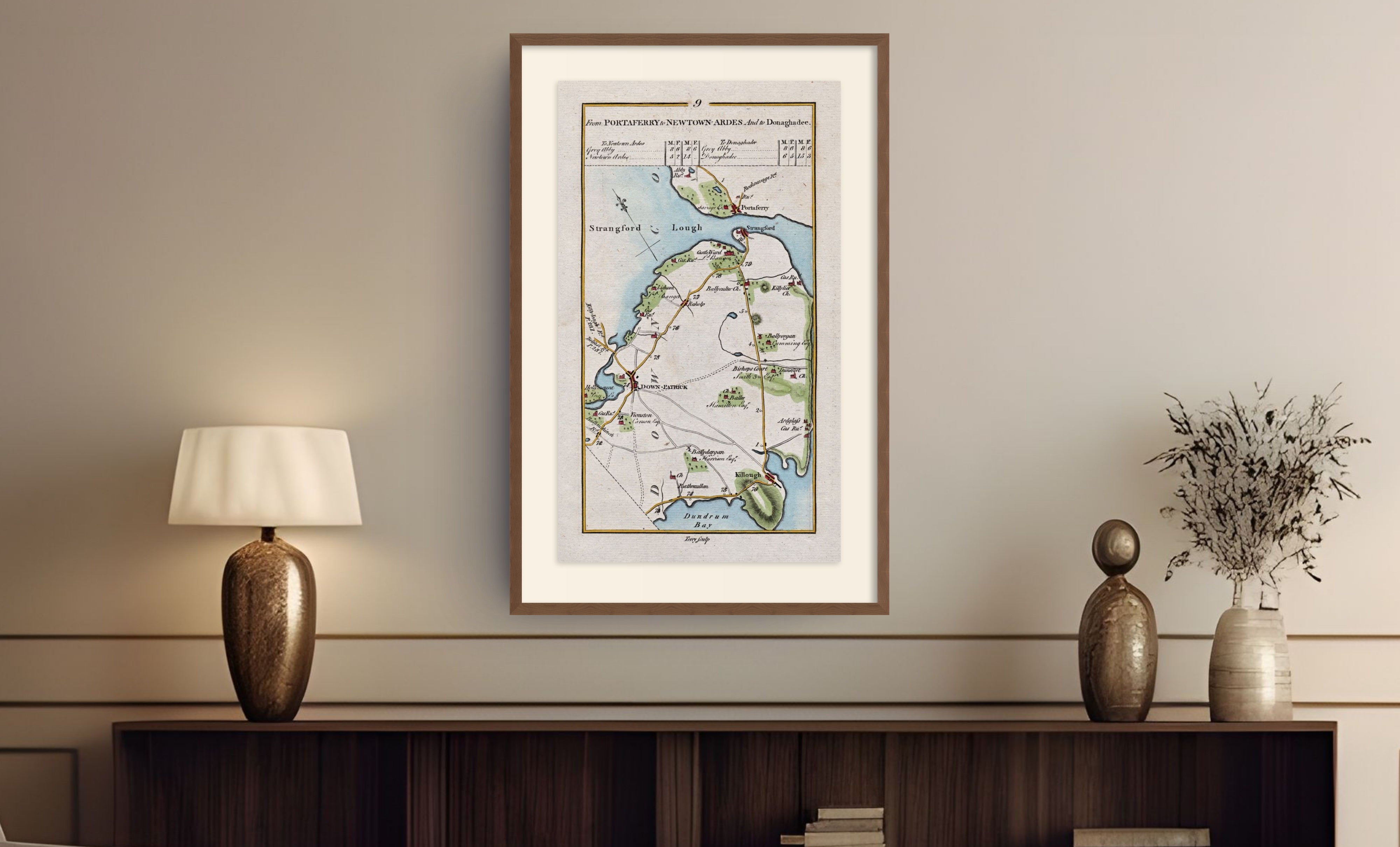 Framed antique Ireland road map of Downpatrick, Strangford, Portaferry and Killough displayed in a styled room interior.