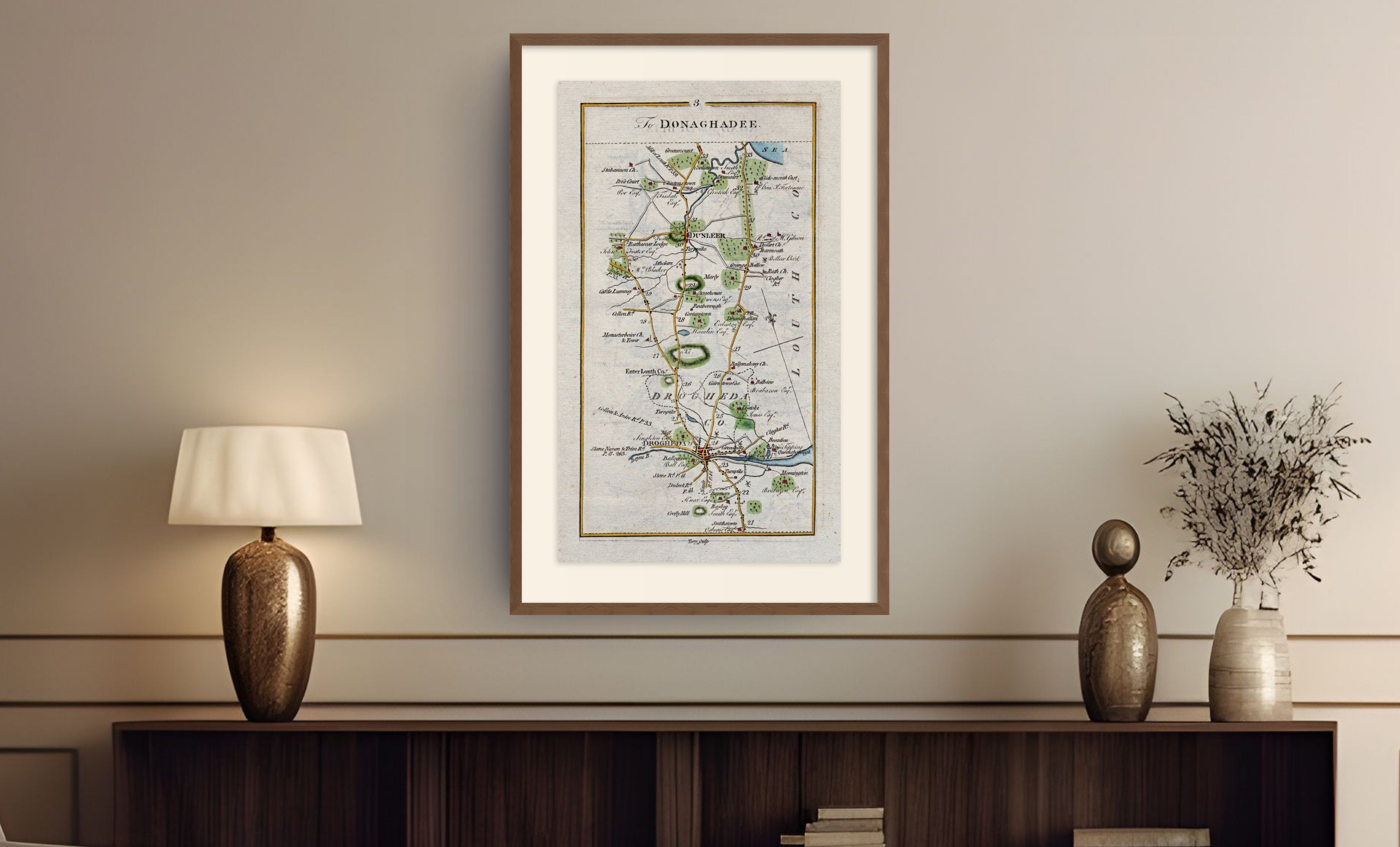 Framed antique Ireland road map of Drogheda, Dunleer, Monasterboice and Stabannon displayed in a styled room interior.