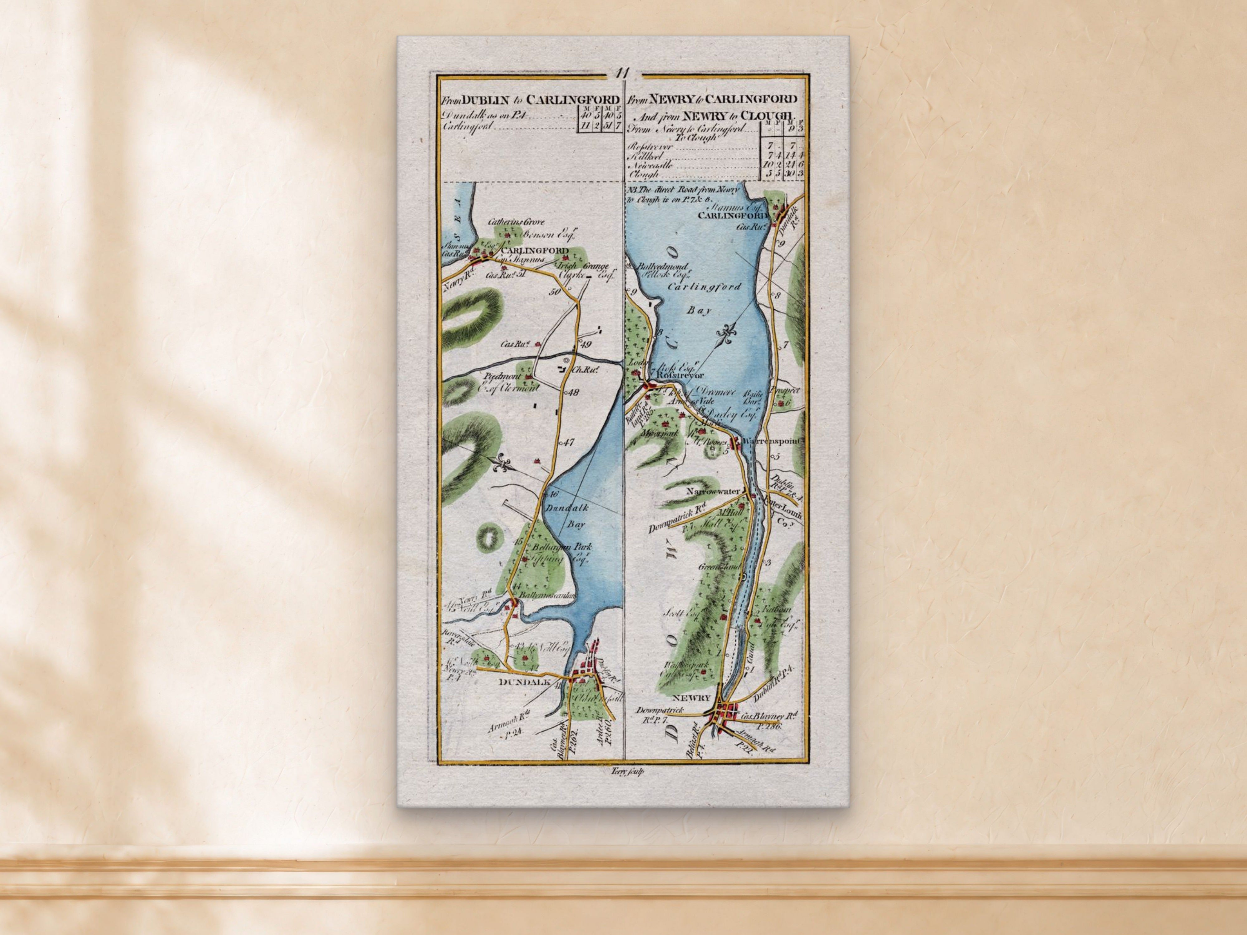 1783 Taylor & Skinner Dundalk, Carlingford, Newry, Warrenpoint and Rostrevor Ireland road map displayed on a light cream wall.