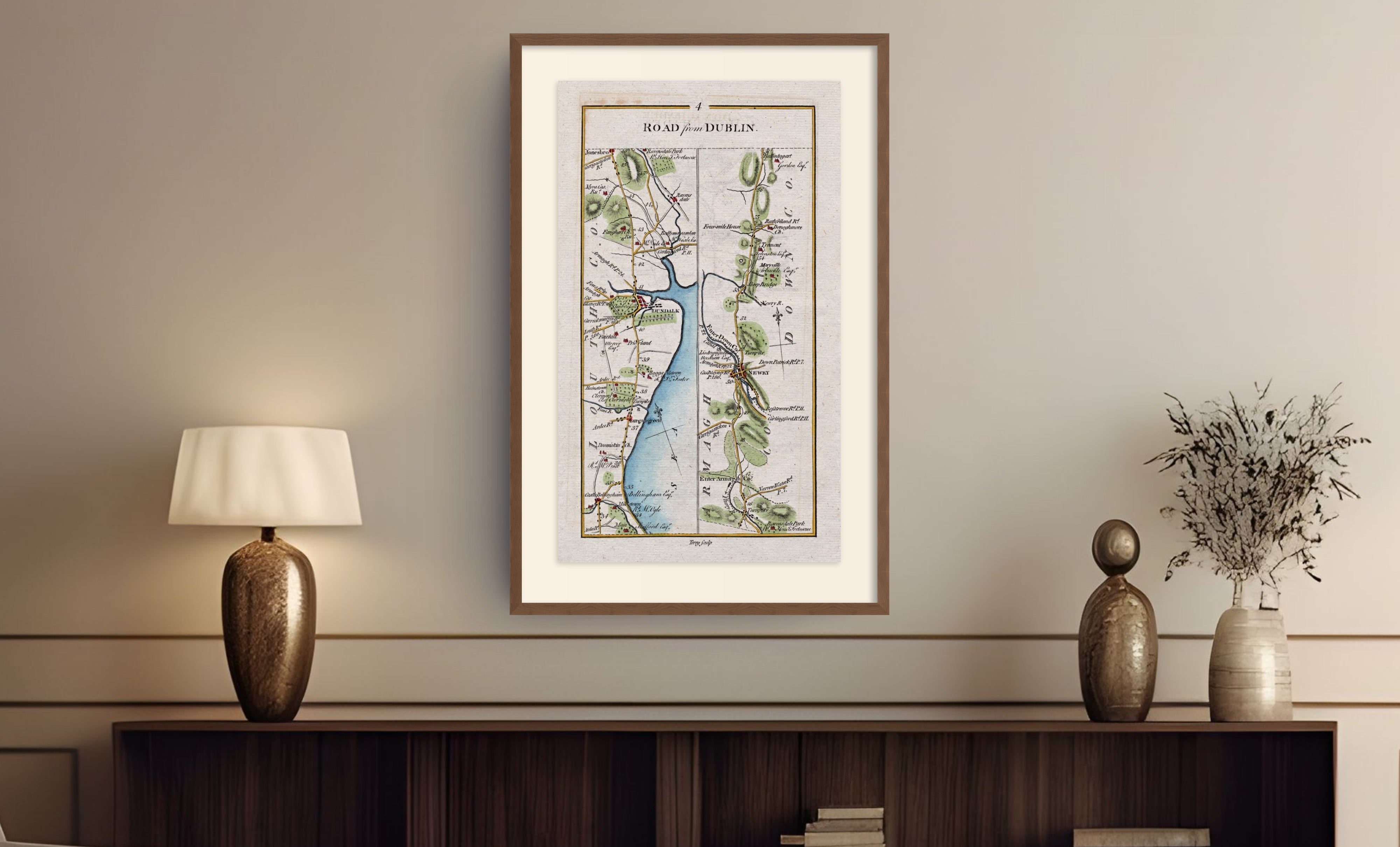 Framed antique Ireland road map of Dundalk, Newry, Castlebellingham and Dromiskin displayed in a styled room interior.