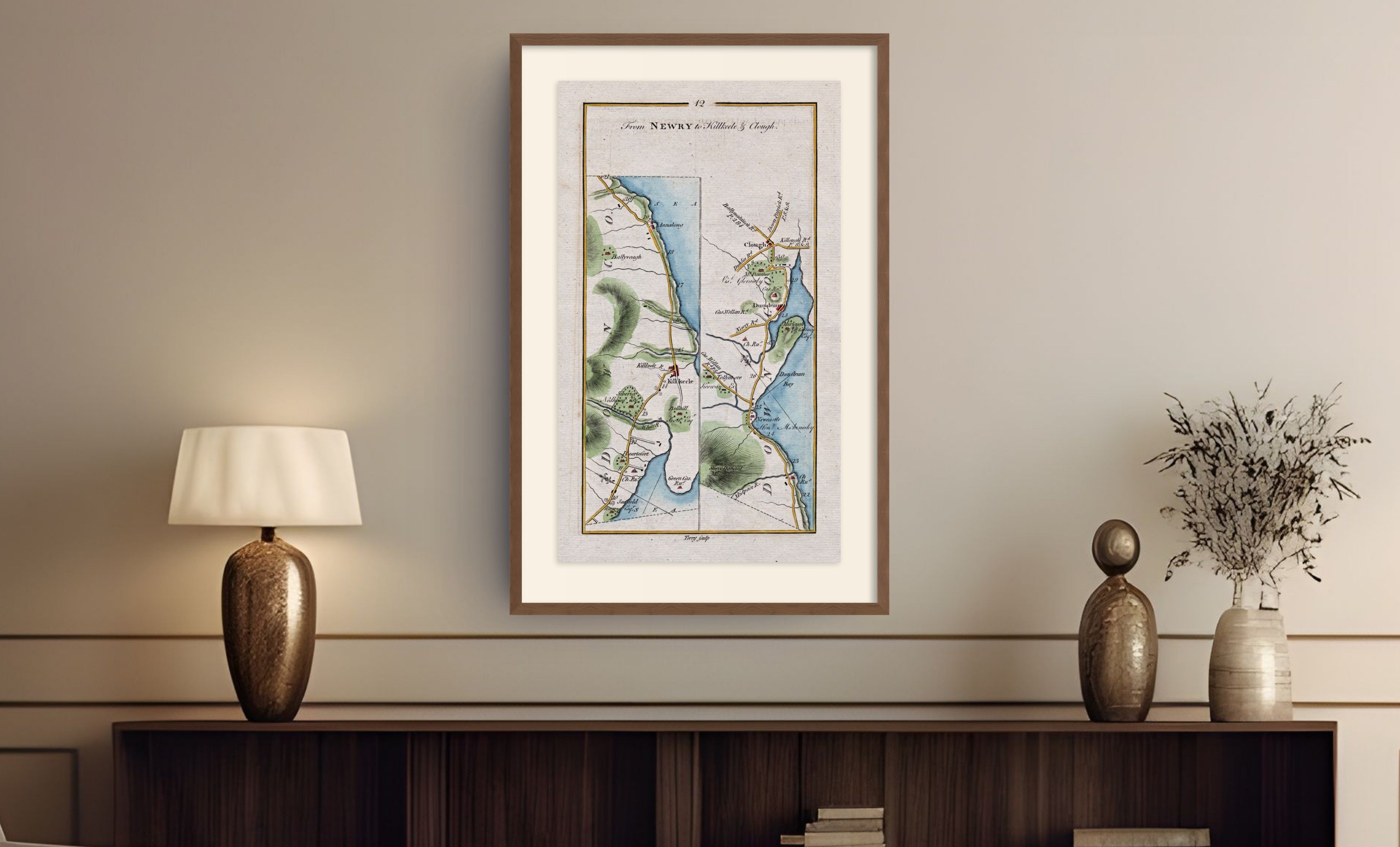Framed antique Ireland road map of Kilkeel, Newcastle, Dundrum, Annalong and Clough displayed in a styled room interior.