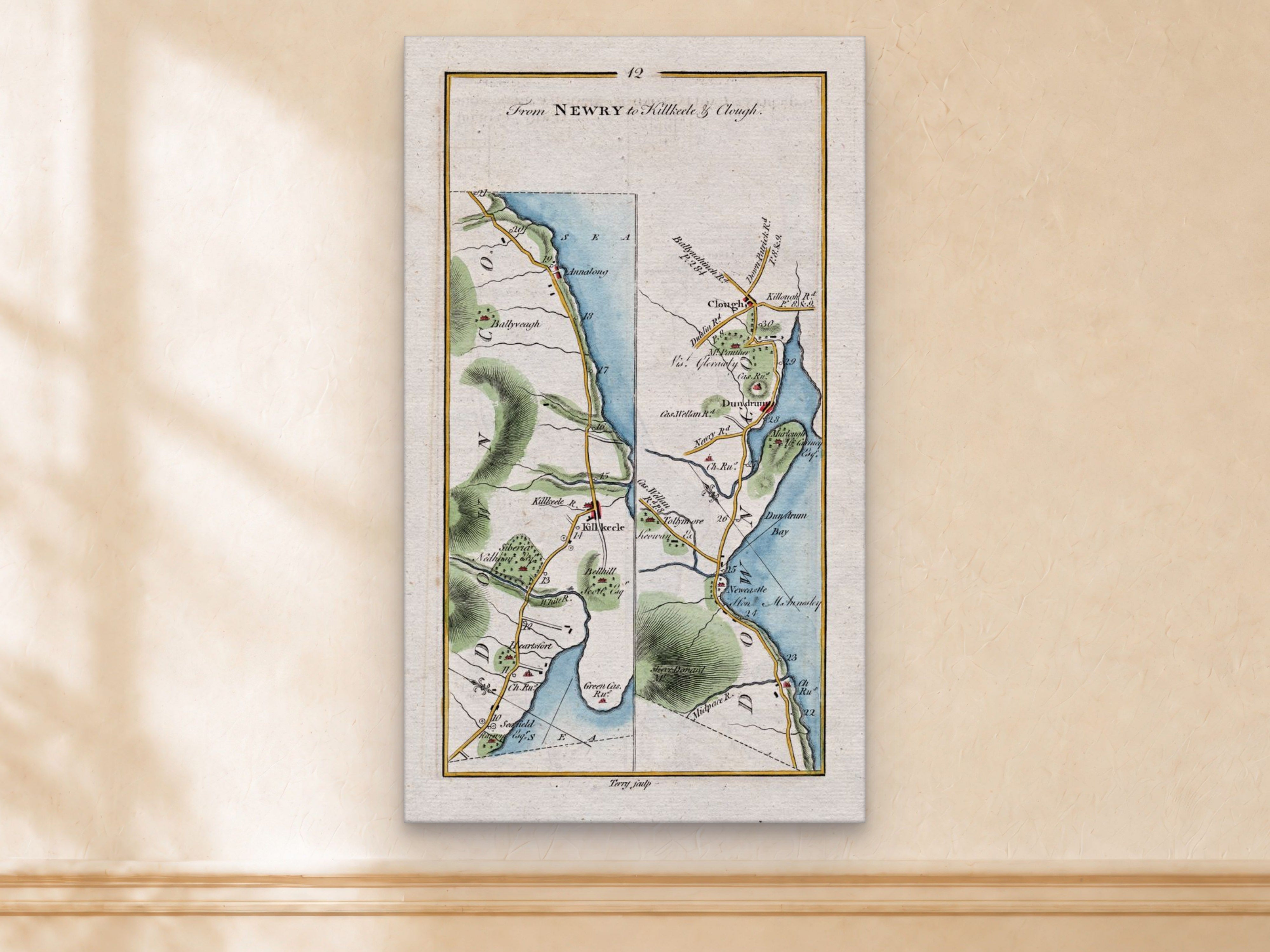 1783 Taylor & Skinner Kilkeel, Newcastle, Dundrum, Annalong and Clough Ireland road map displayed on a light cream wall.