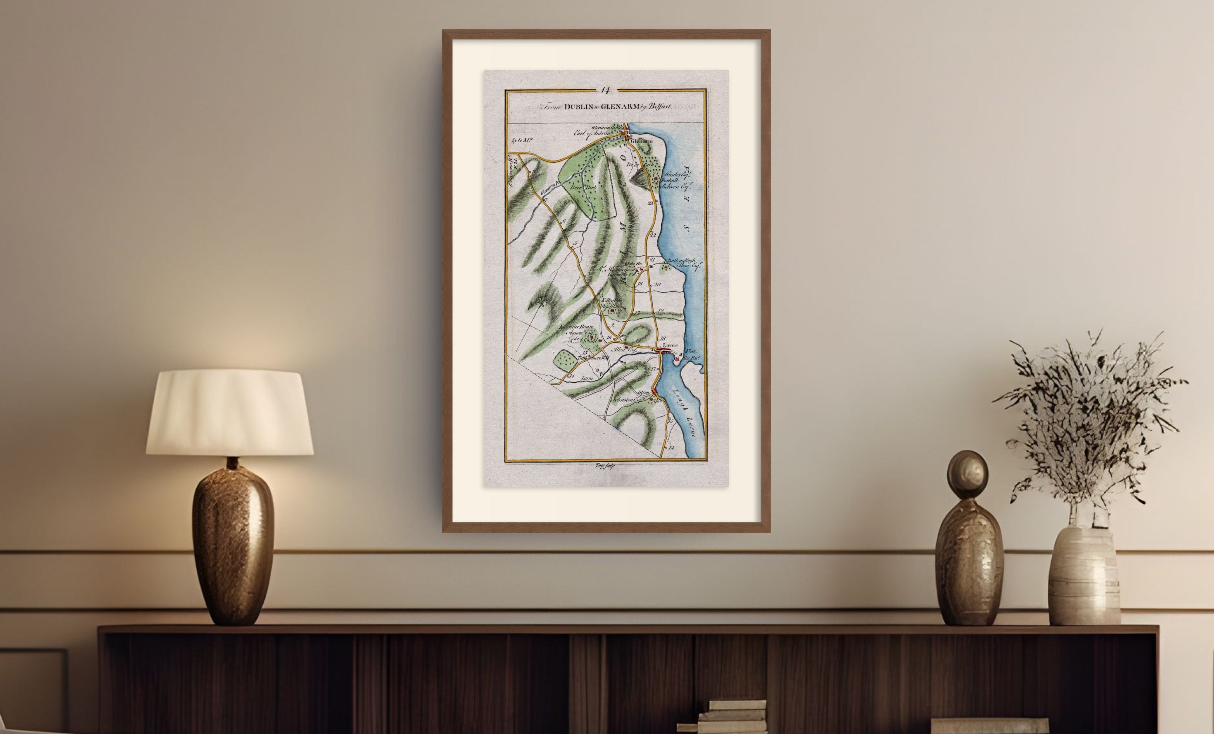 Framed antique Ireland road map of Larne, Glenarm, Ballygally and Glynn displayed in a styled room interior.