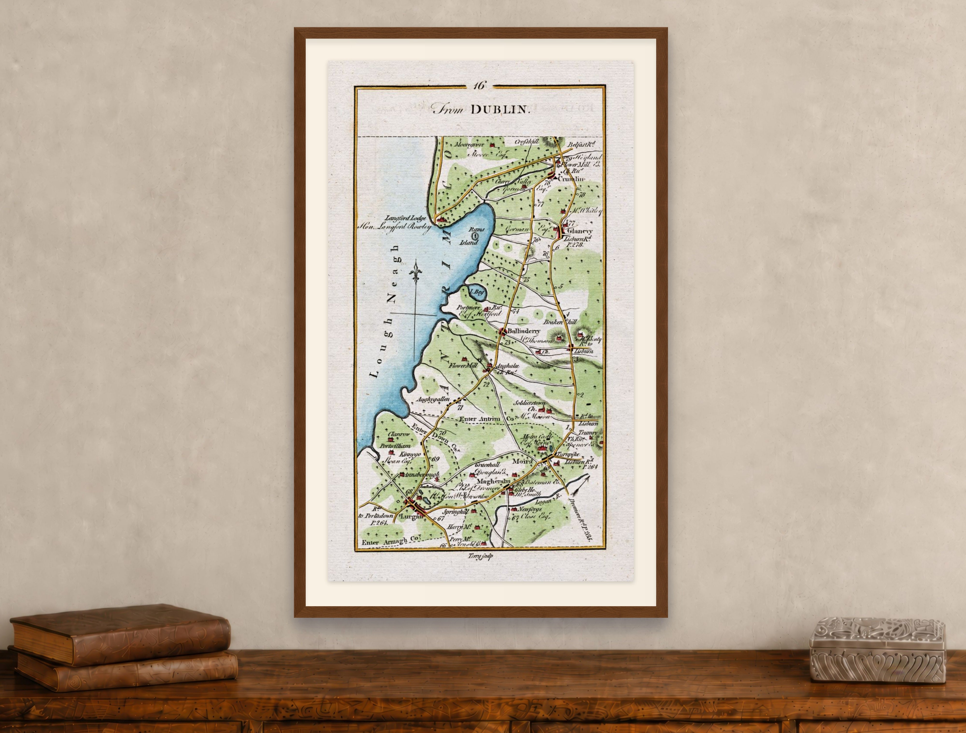 Framed 1783 Taylor & Skinner Lurgan, Moira, Crumlin, Glenavy and Ballinderry, Ireland road map displayed above an antique wooden cabinet.