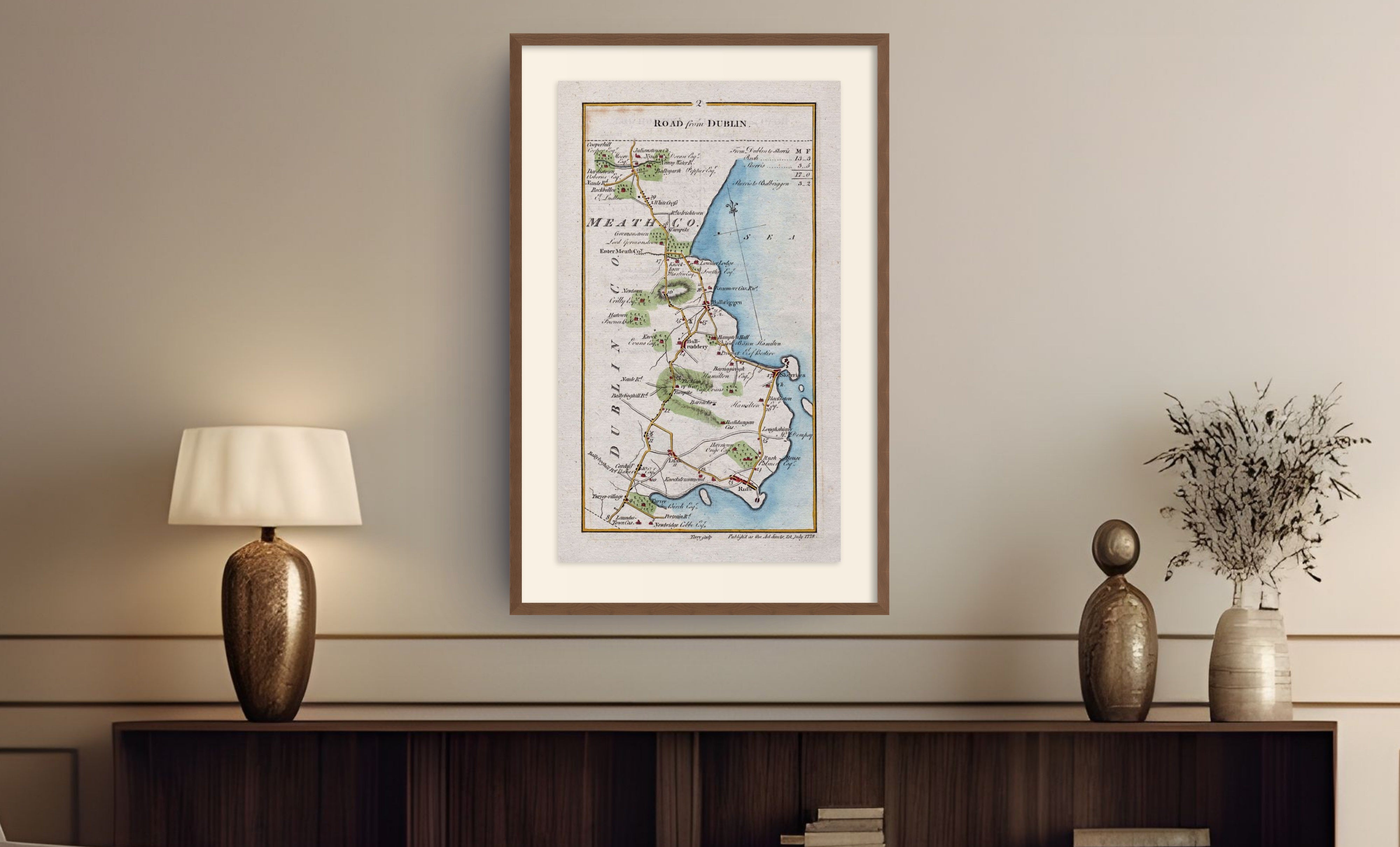 Framed antique Ireland road map of Lusk, Rush, Skerries and Balbriggan displayed in a styled room interior.