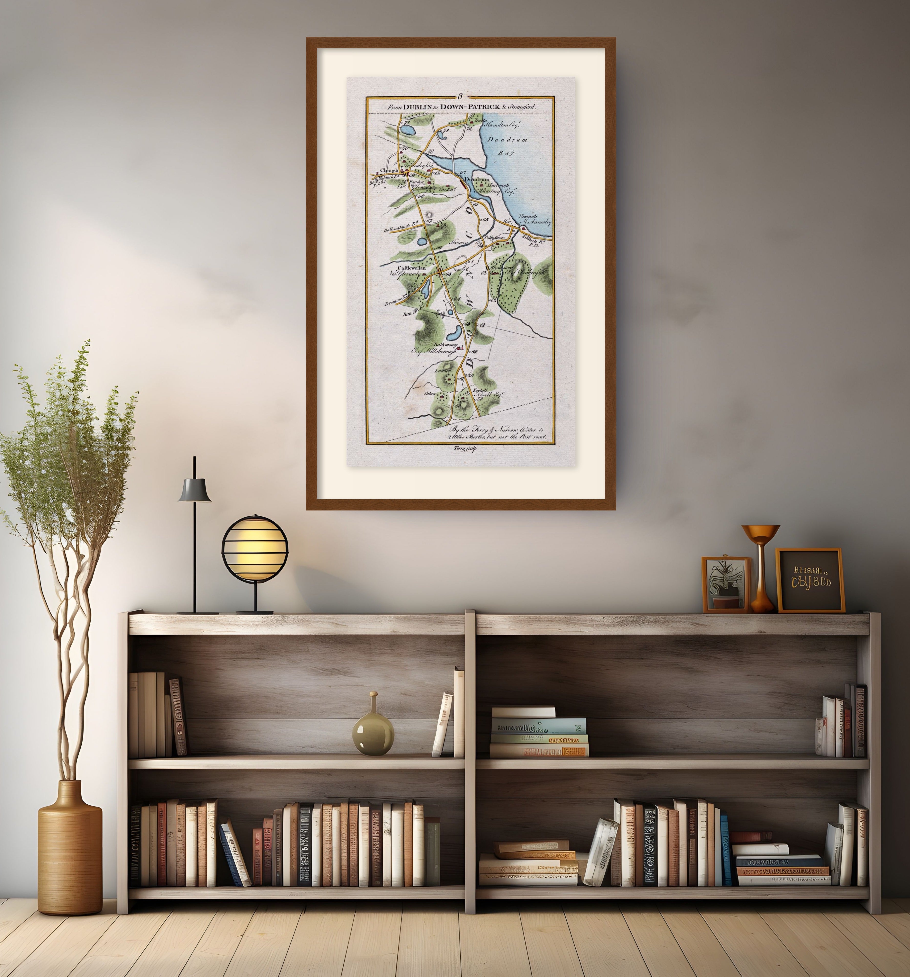 Framed antique Ireland road map of Newcastle, Castlewellan, Dundrum and Clough displayed in a modern interior.