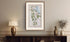 Framed antique Ireland road map of Newcastle, Castlewellan, Dundrum and Clough displayed in a styled room interior.