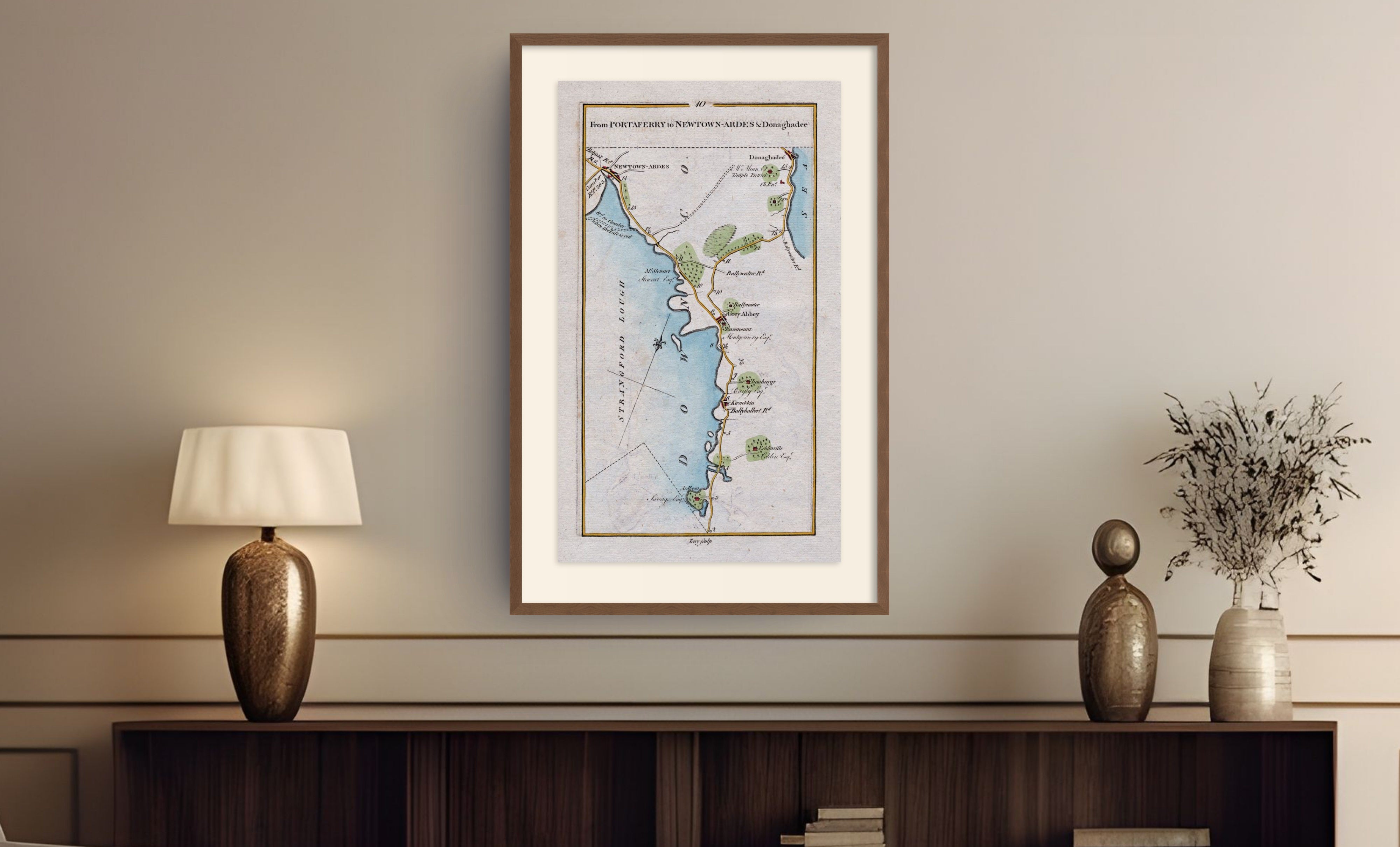 Framed antique Ireland road map of Newtownards, Donaghadee, Greyabbey and Kircubbin displayed in a styled room interior.