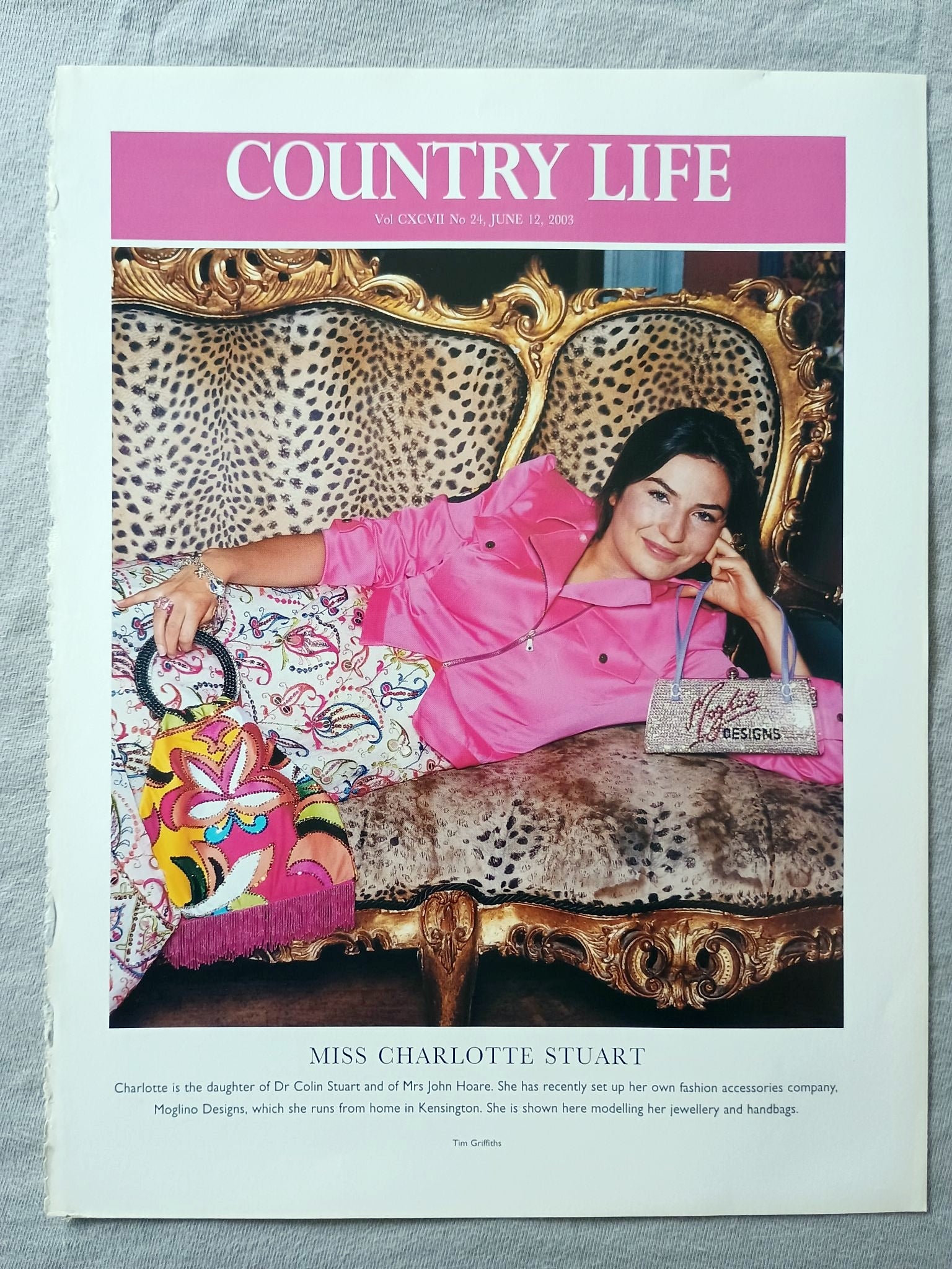 Miss Charlotte Stuart - Charlotte is the daughter of Dr Colin Stuart and of Mrs John Hoare. She has recently set up her own fashion accessories company. Moglino Designs, which she runs from home in Kensington. She is shown here modelling her jewellery and handbags
