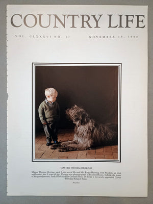 Thomas Herring Country Life Magazine Portrait November 19, 1992. CLXXXVI No. 47.

Master Thomas Herring, aged 2, the son of Mr and Mrs Roger Herring, with Plunkett, an Irish wolfhound, also 2 years of age. Thomas was photographed at Boxford House, Suffolk, the home of his grandparents, Lady Hilda and Dr Conrad Swan. Dr Swan is the newly appointed Garter Principal King of Arms
