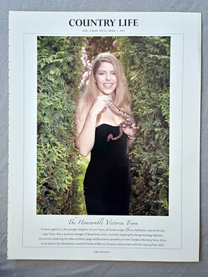 The Honourable Victoria Tryon - Victoria, aged 25, is the younger daughter of Lord Tryon, of Fordie Lodge, Comrie, Perthshire, and of the late Lady Tryon. She is assistant manager of Boucheron, and is currently studying for her gemmology diploma. She will be modelling this dress by Rena Lange and Boucheron jewellery at next Tuesday's Berkeley Dress Show, to be held at the Dorchester, in aid of Friends of Bolivia. Victoria is shown here with her royal python, Mali.